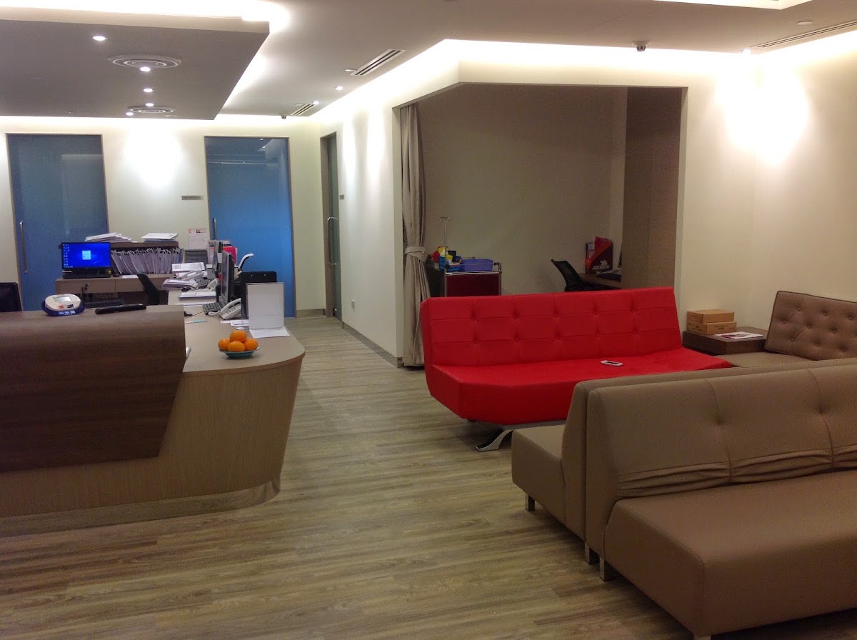 A completed office reception fit-out by Vision 2 Engineering, with curved timber counter and cove lighting