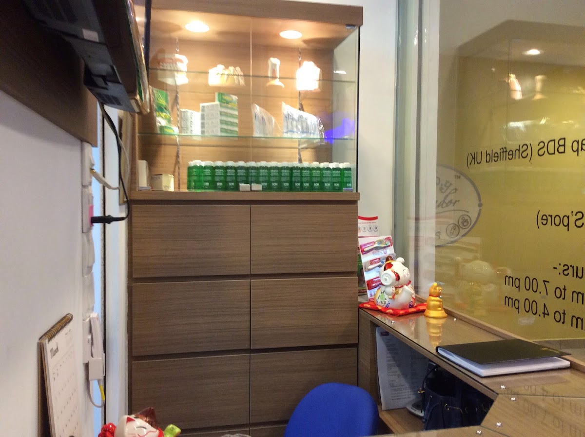 Dental clinic reception joinery with lit glass display cabinet