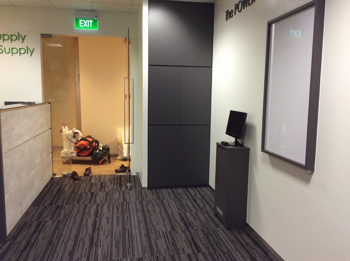 An office fit-out in progress, with new joinery, emergency exit signage and wall graphics installed